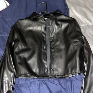 A cropped leather thin jacket. It’s Cotten on the inside. Has all the buttons.